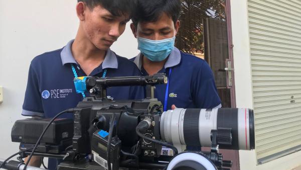 Two students behind the camera