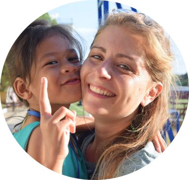 Sophie, former volunteer at PSE, with a child