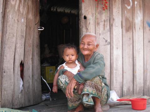 Une veille dame et son petit-enfant devant leur habitation dans une zone de grande pauvreté Une veille dame et son petit-enfant devant leur habitation dans une zone de grande pauvreté